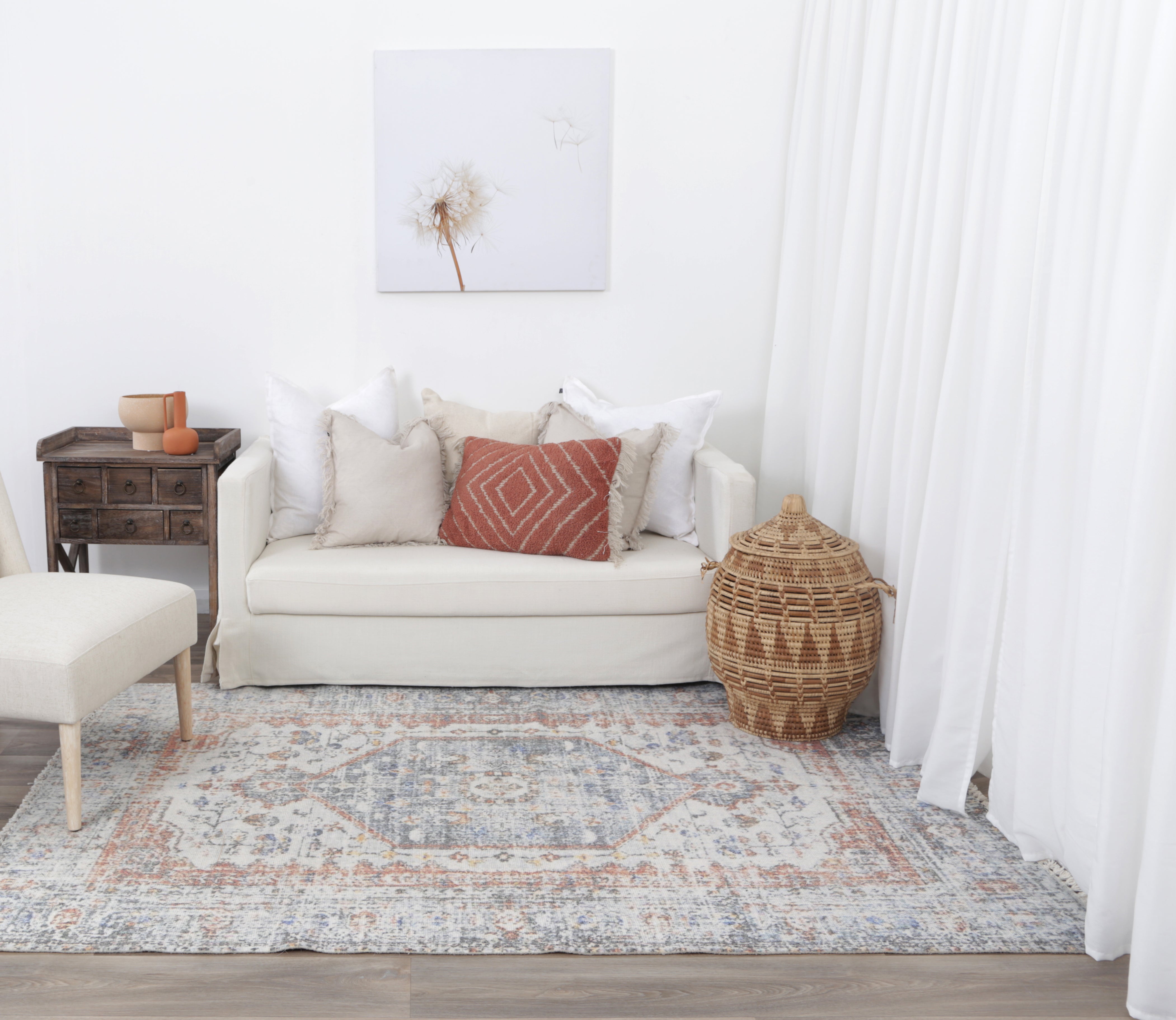 Agora Classic Blue & Terracotta Wool Rug in living room with furnishings on blonde flooring