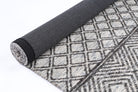 Alayah Diamond Trellis Grey & taupe Rug rolled with black cotton backing on light flooring