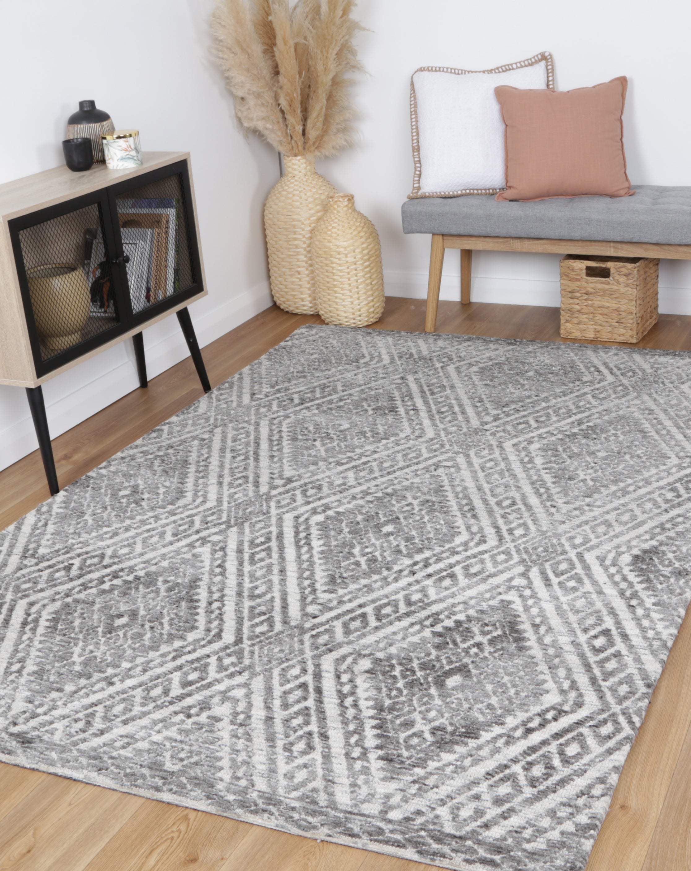 Alayah Zalij silver & taupe Rug in living room with light flooring and wooden accesories with grey bench